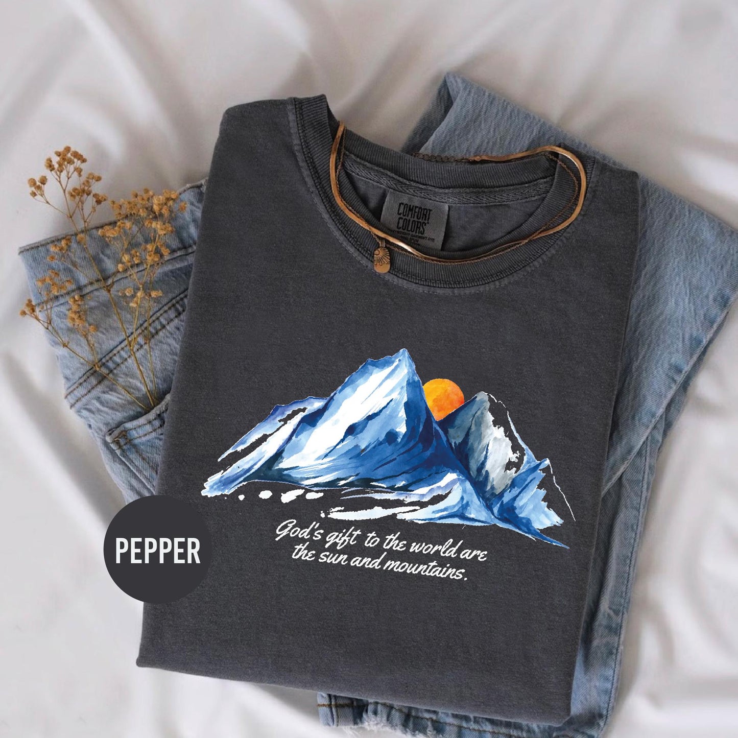 a t - shirt with a picture of a mountain on it