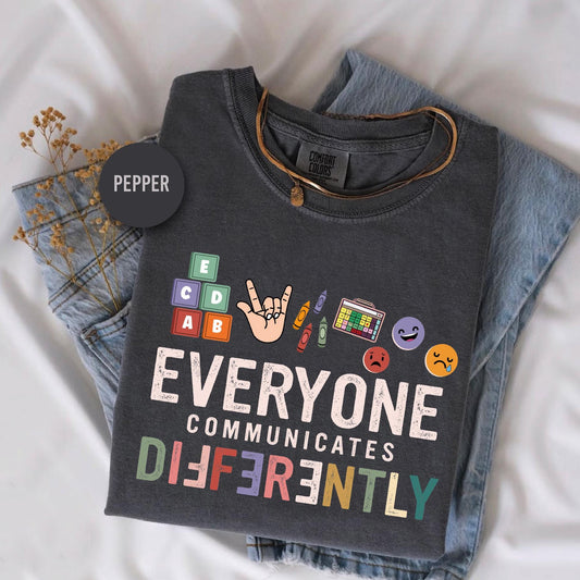 a t - shirt that says everyone communicates differently