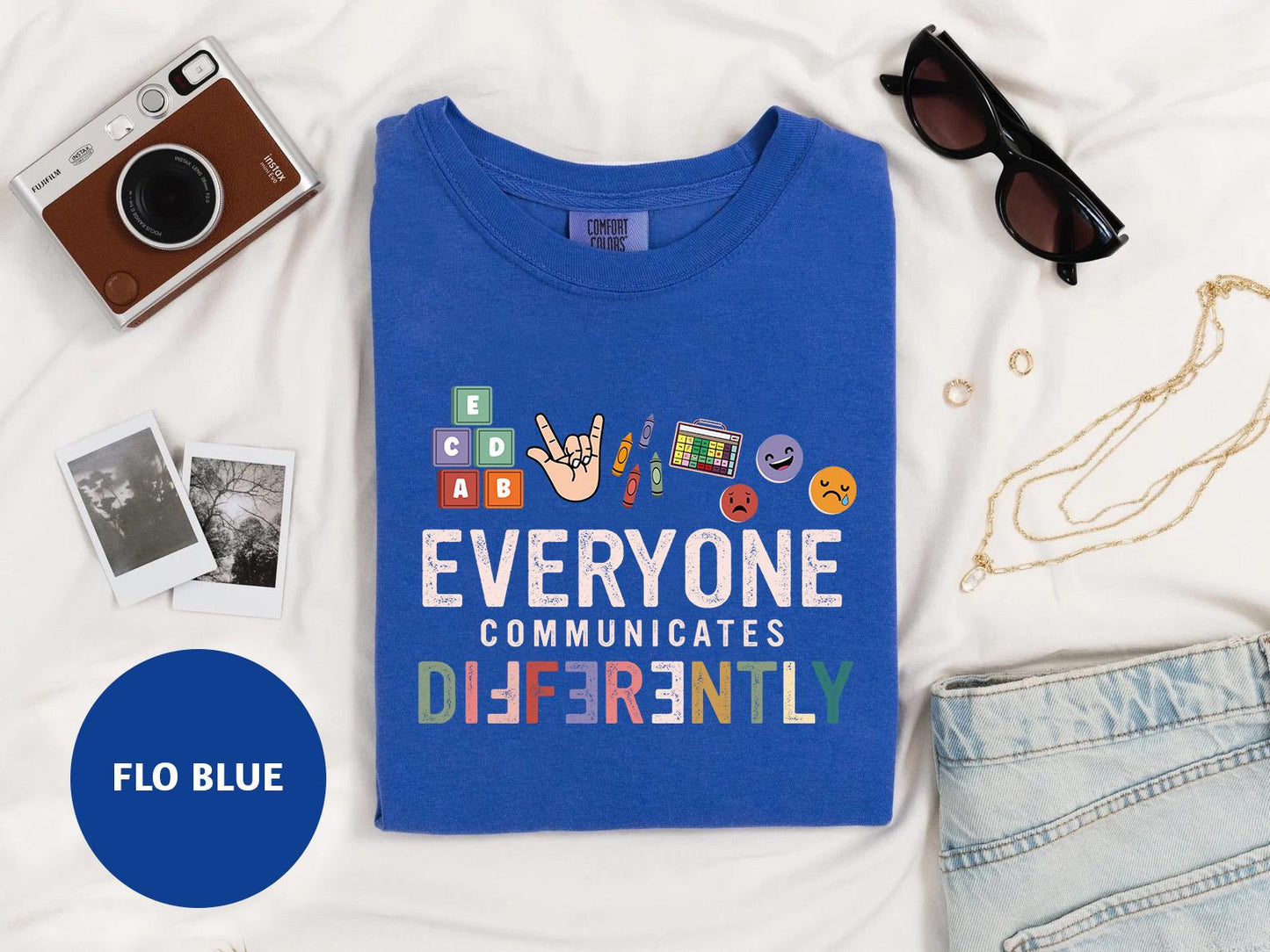 a blue t - shirt with the words everyone communicate differently on it