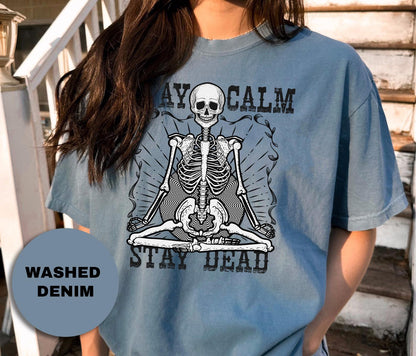a woman wearing a blue shirt with a skeleton on it