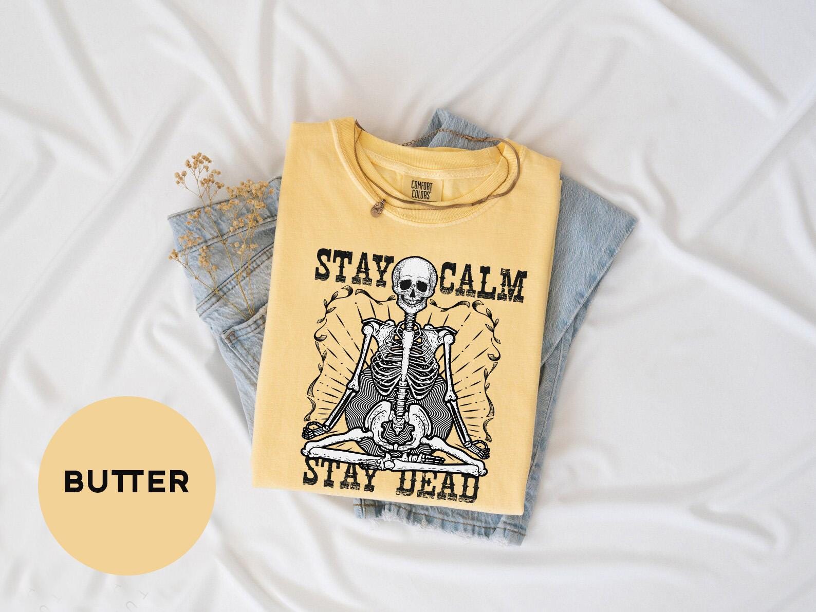 a yellow shirt with a skeleton on it