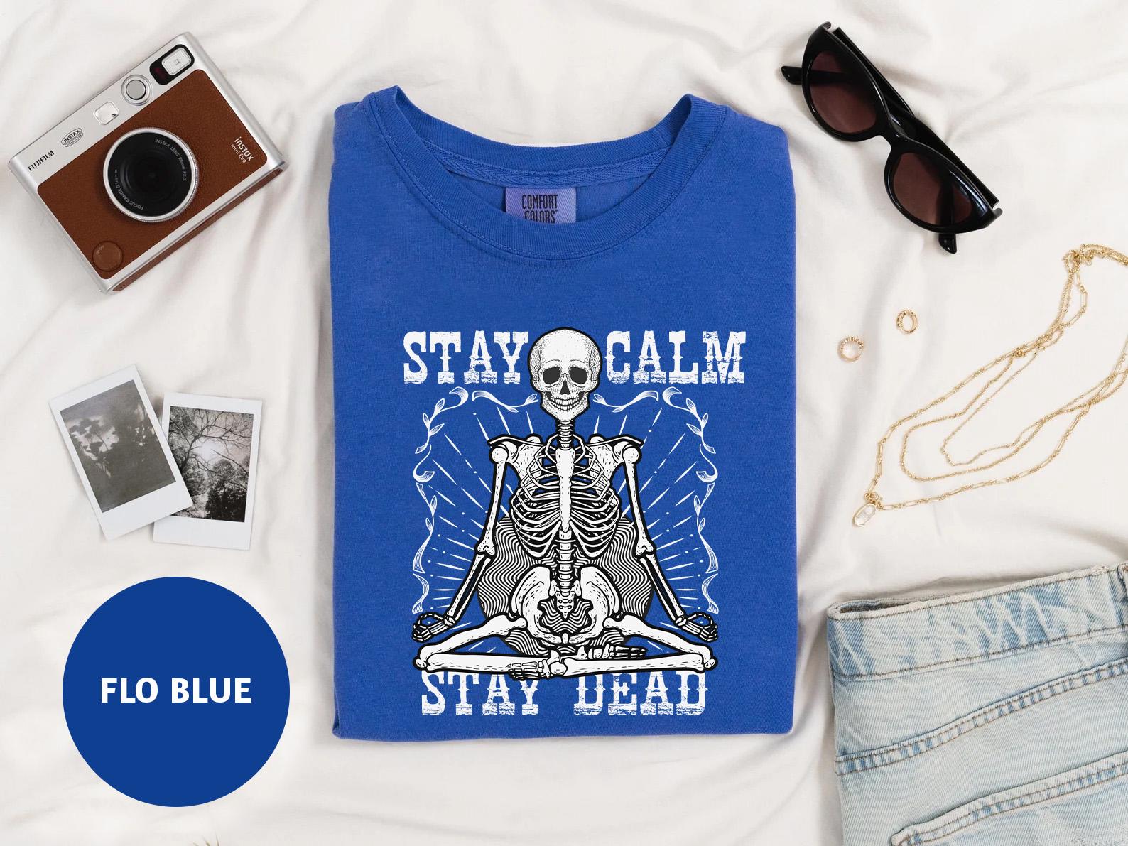 a t - shirt with a skeleton on it and a camera next to it