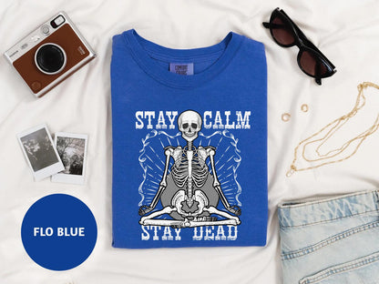 a t - shirt with a skeleton on it and a camera next to it