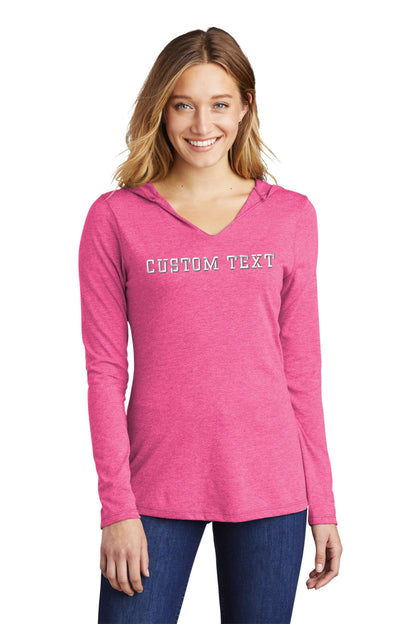 a woman wearing a pink hoodie that says text mom