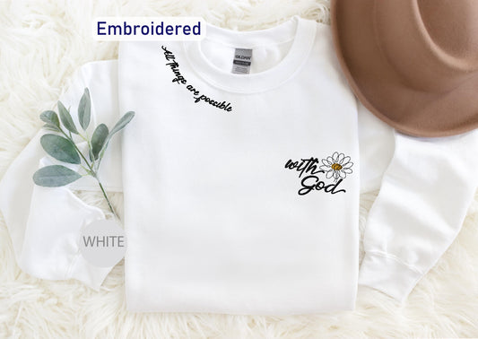 a white shirt with a flower on it and a brown hat