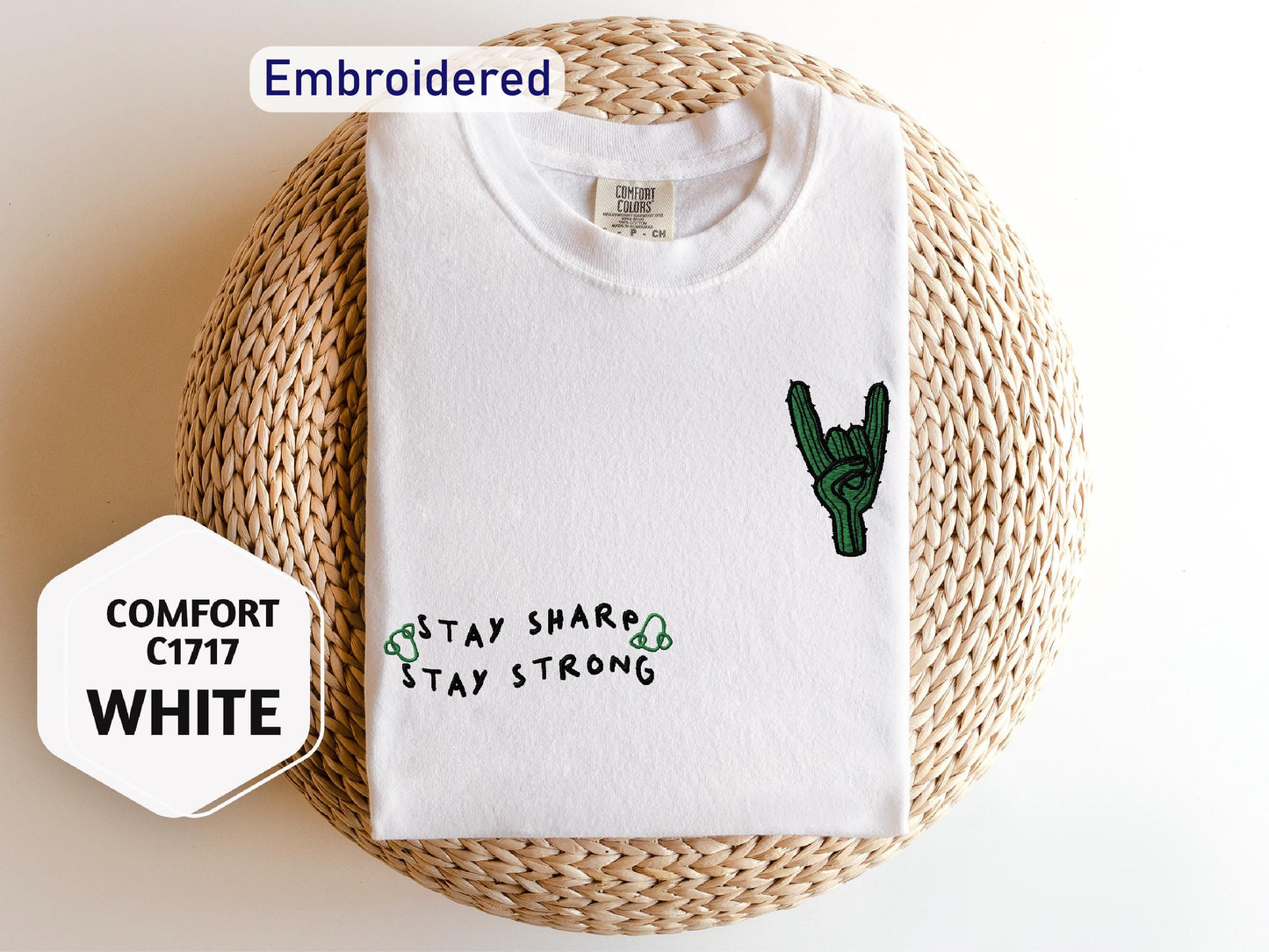 a white shirt with a cactus embroidered on it