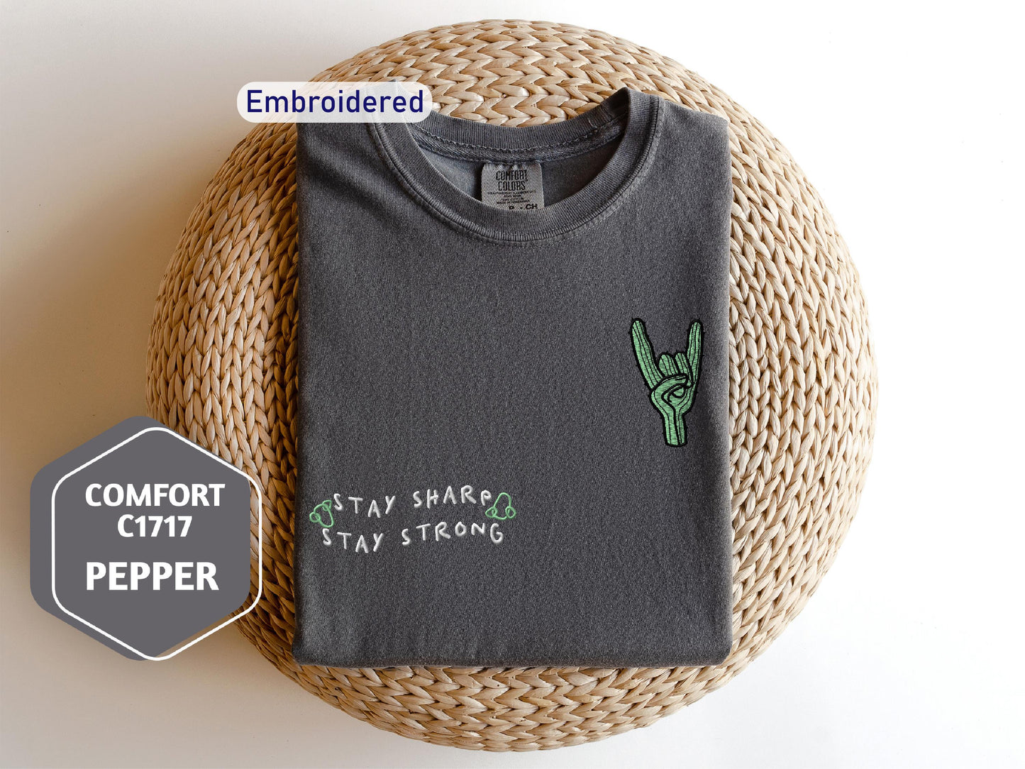 a gray t - shirt with a green peace sign on it