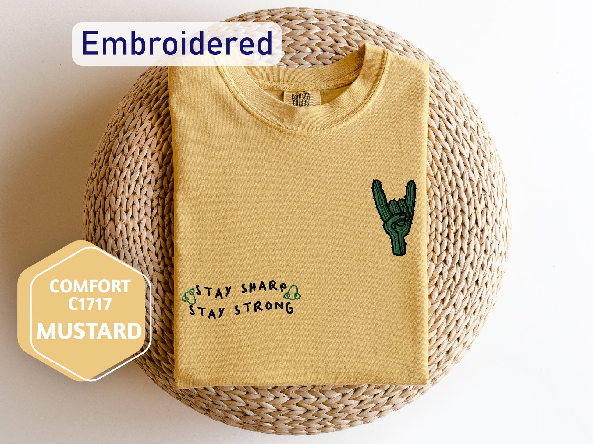 a yellow shirt with a green cactus on it