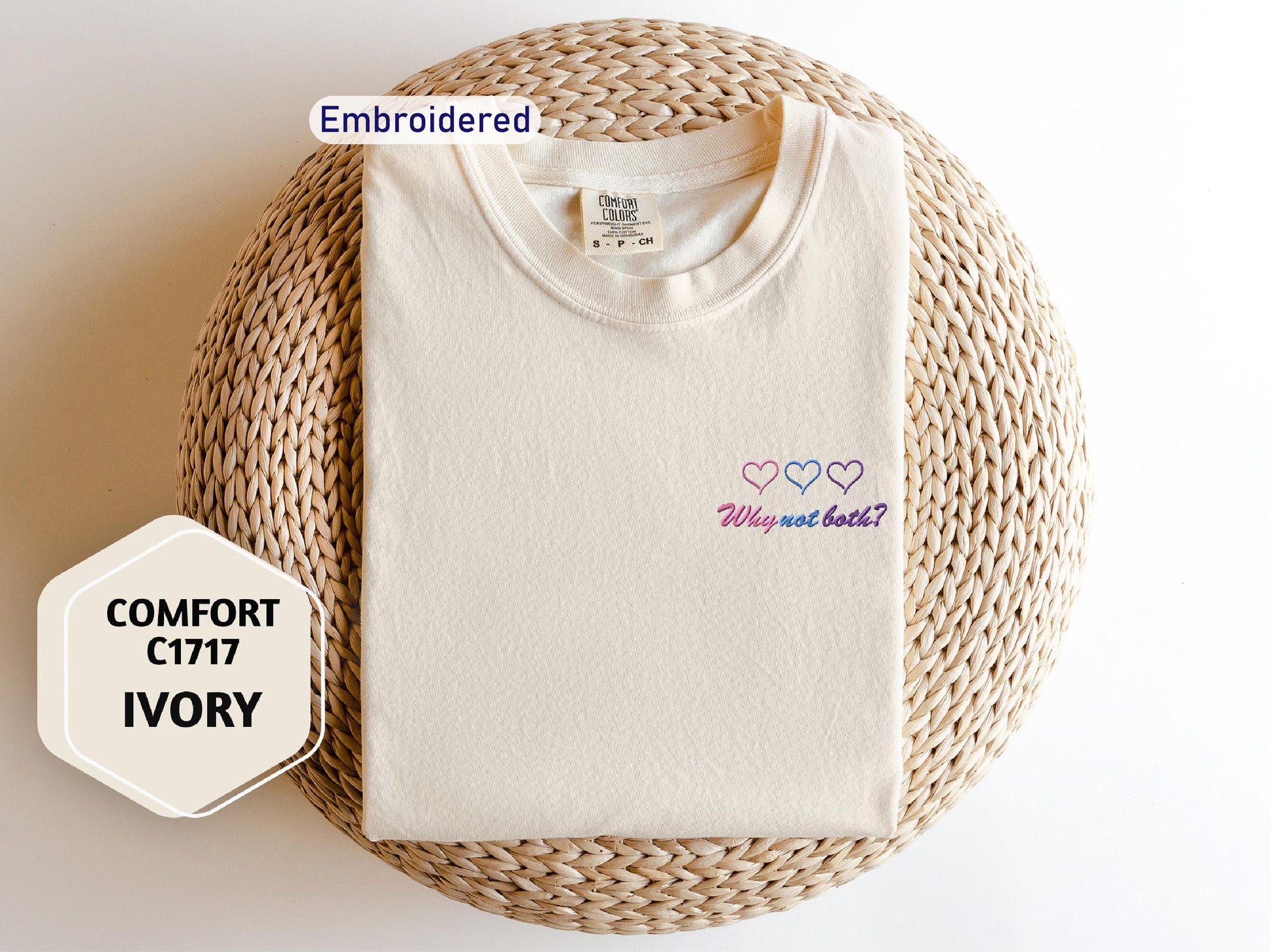a white t - shirt with a pink heart embroidered on it
