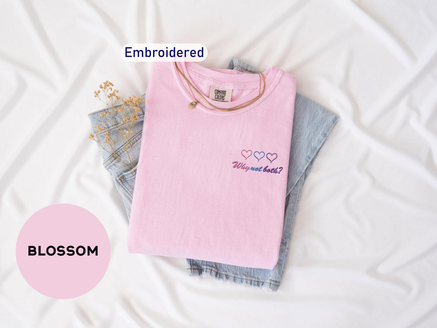 a pink t - shirt with embroidered words on it
