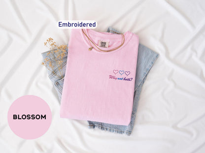 a pink t - shirt with embroidered words on it