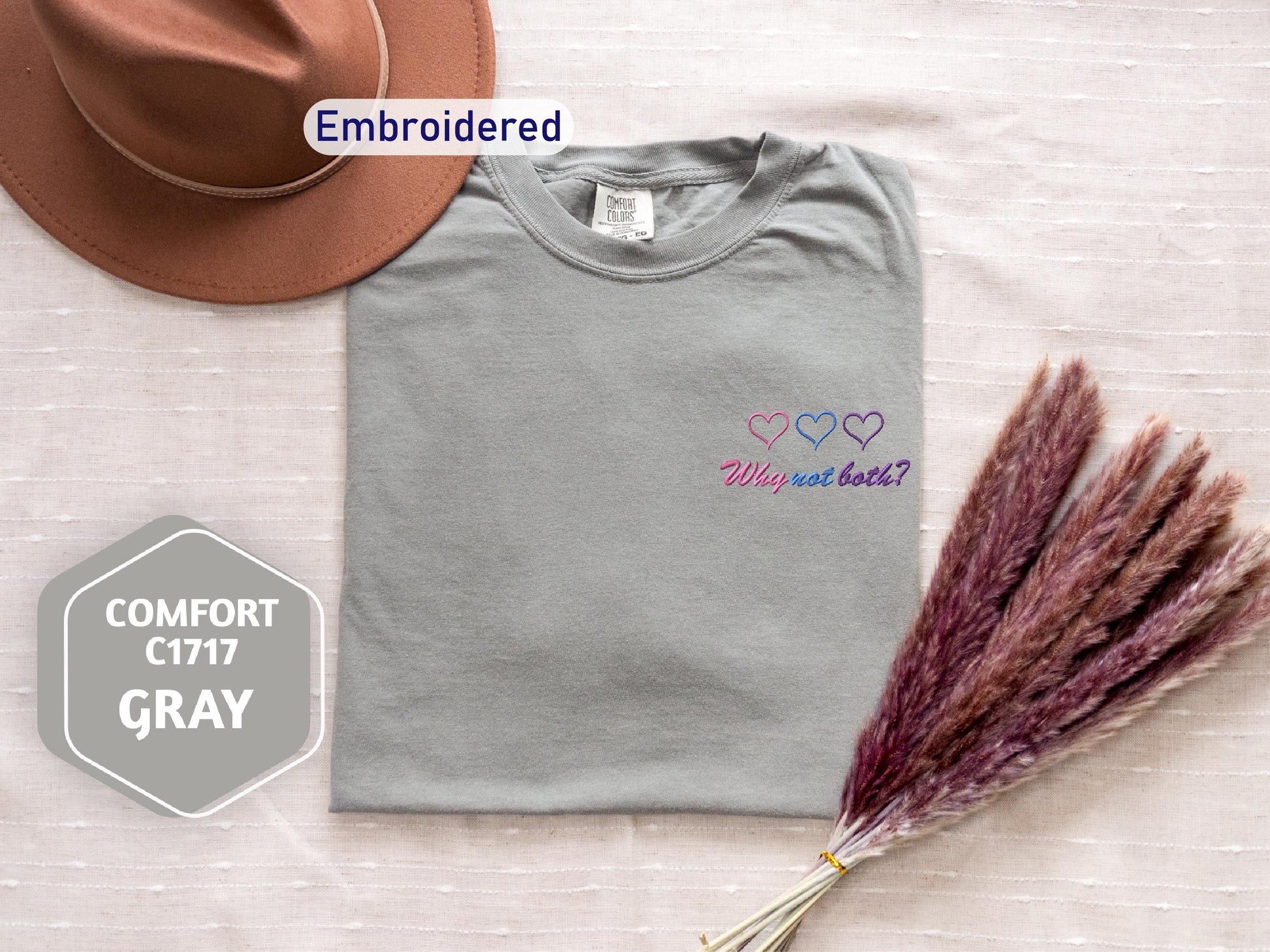 a hat, t - shirt, and dried grass on a bed