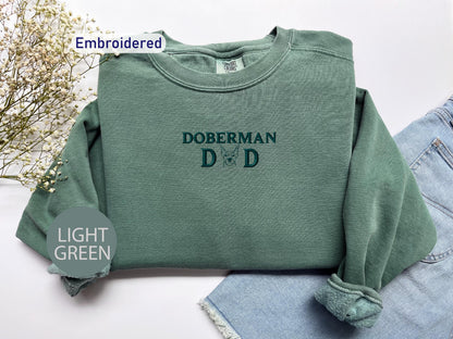 a green sweatshirt with the words dobermann d on it