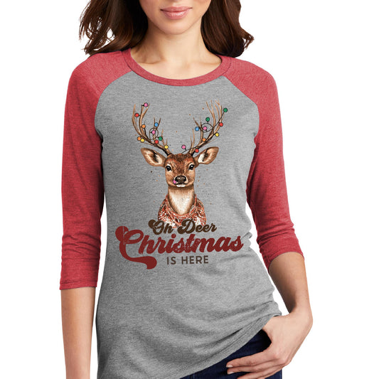 a woman wearing a christmas shirt with a deer on it