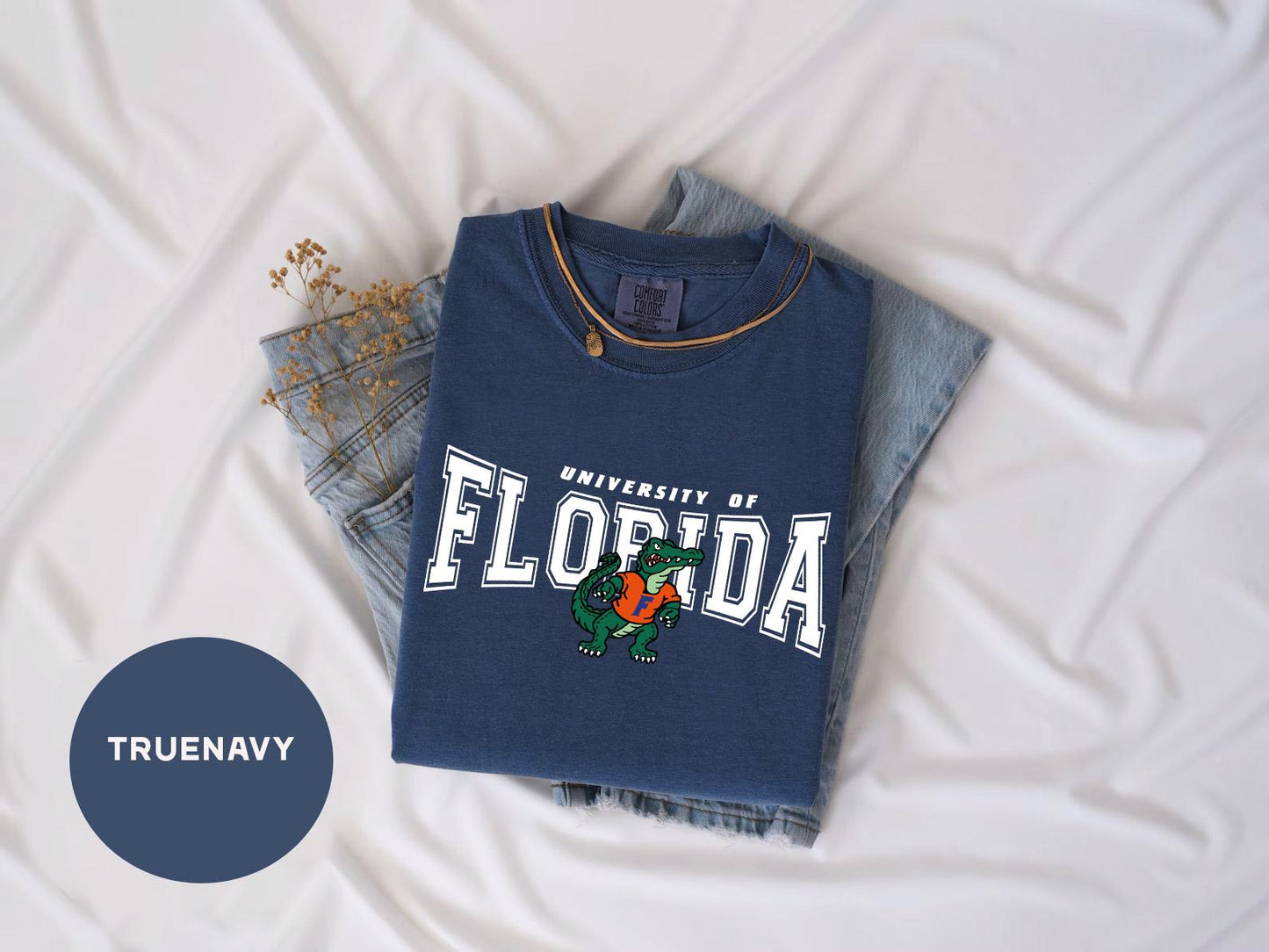 a t - shirt that says university of florida on it next to a pair of
