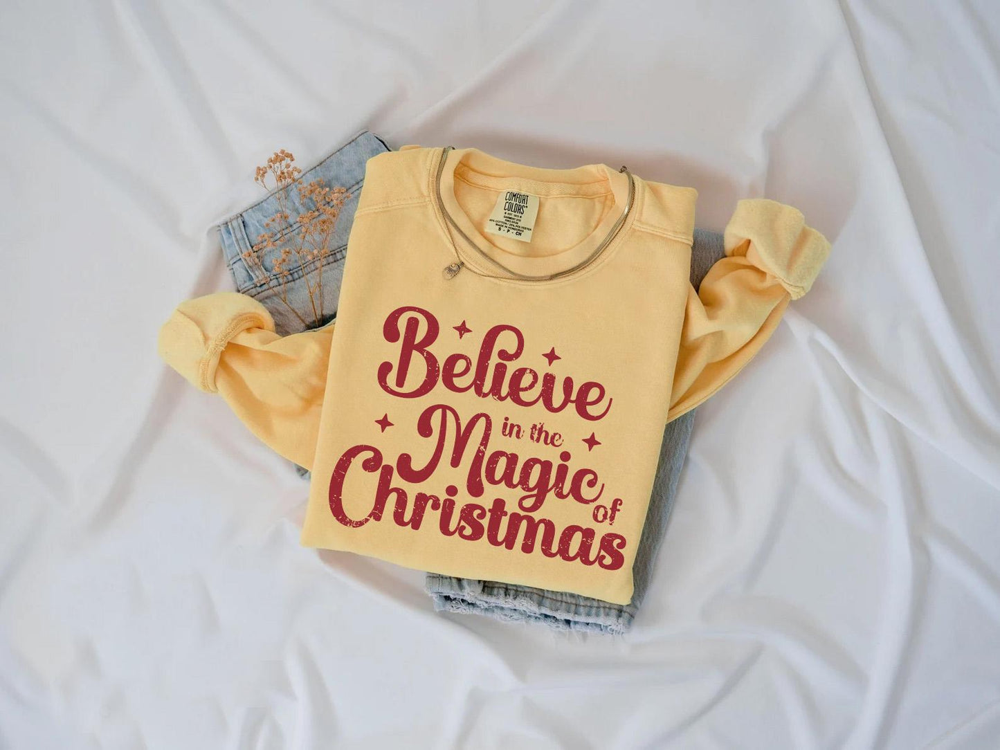 a t - shirt that says believe in the magic of christmas