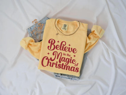 a t - shirt that says believe in the magic of christmas