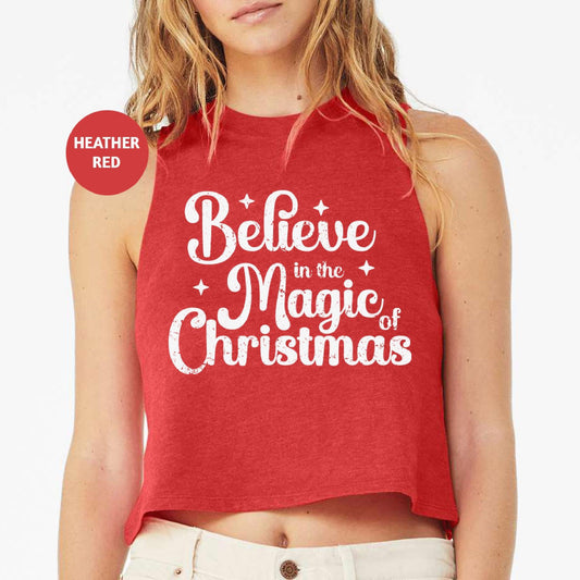 a woman wearing a red believe in the magic of christmas crop top