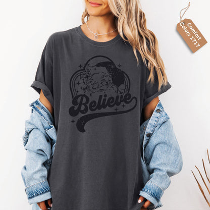 a woman wearing a black believe t - shirt