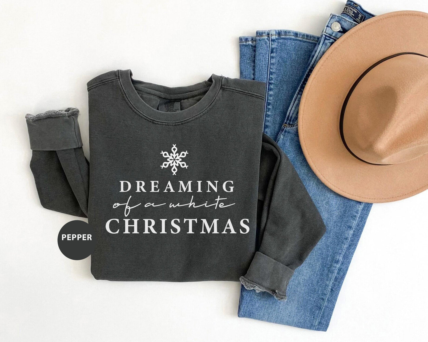 a hat, jeans, and a sweatshirt with the words dreaming of a white christmas