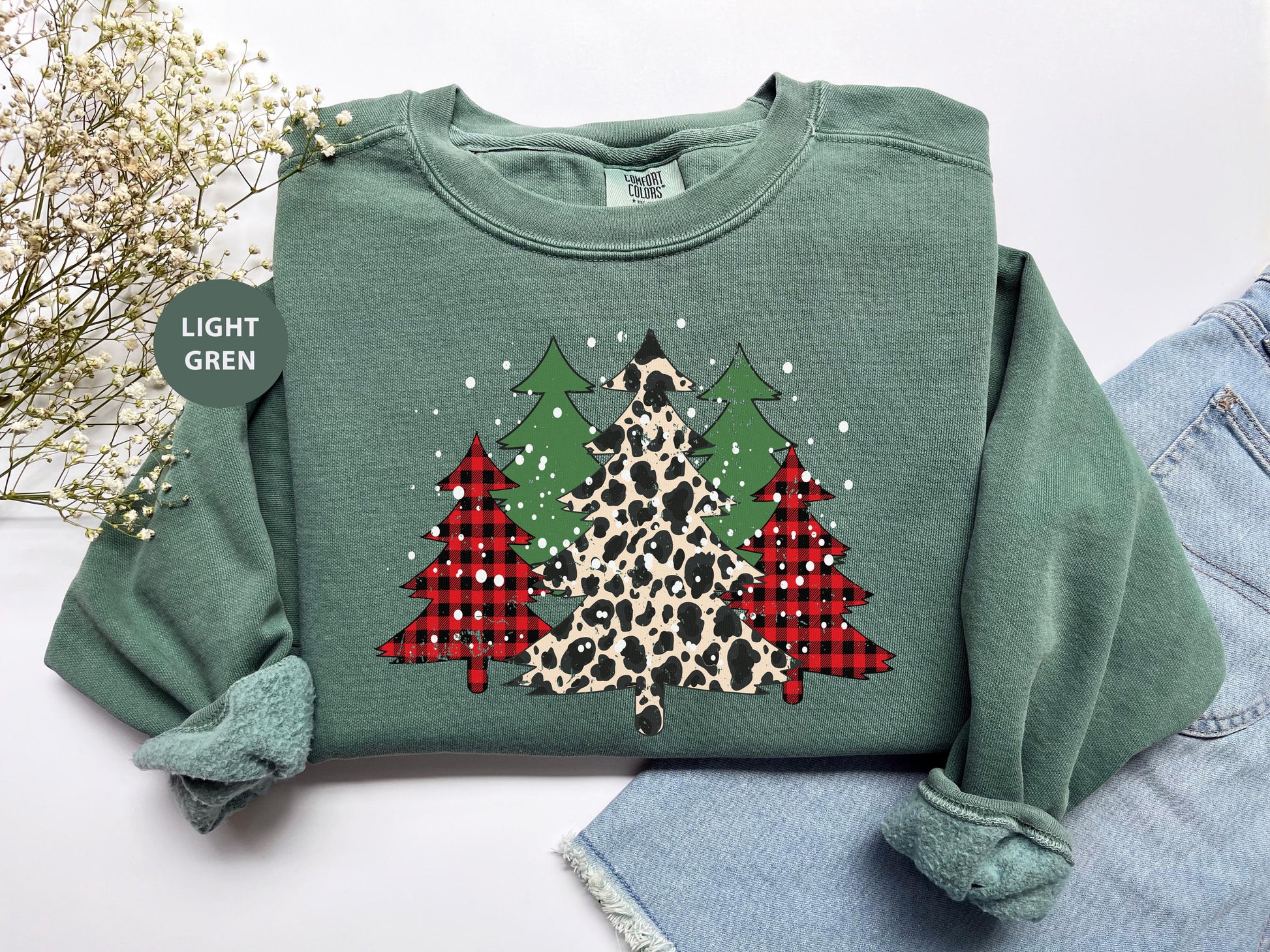 a green sweater with a leopard print christmas tree