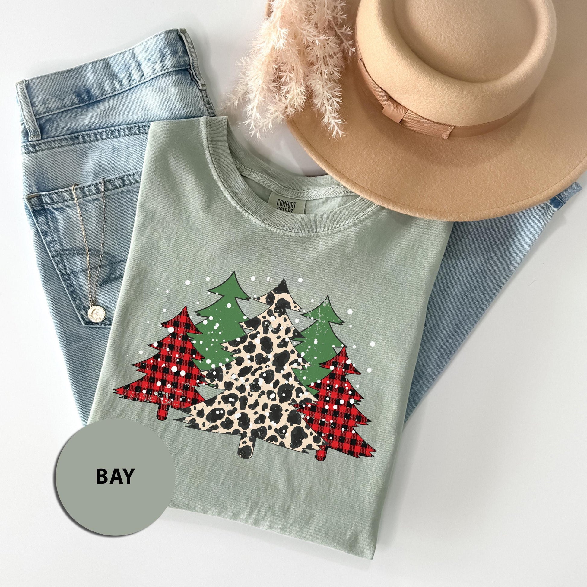 a green shirt with a leopard print on it and a hat next to it