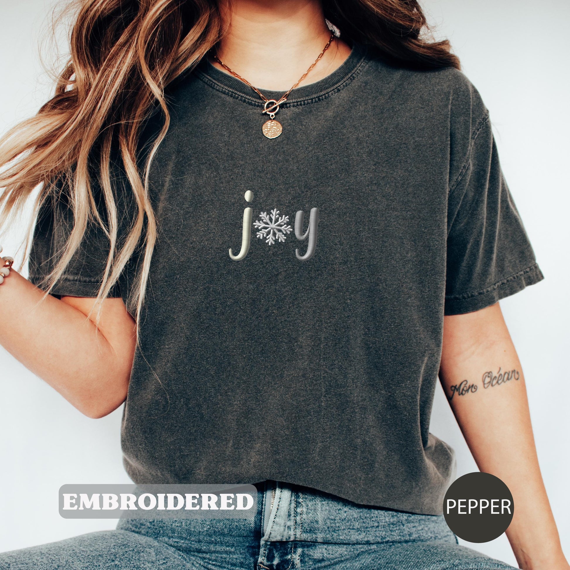 a woman wearing a t - shirt with a snowflake on it