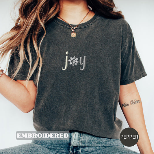 a woman wearing a t - shirt with a snowflake on it