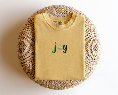 a yellow t - shirt with the word joy on it