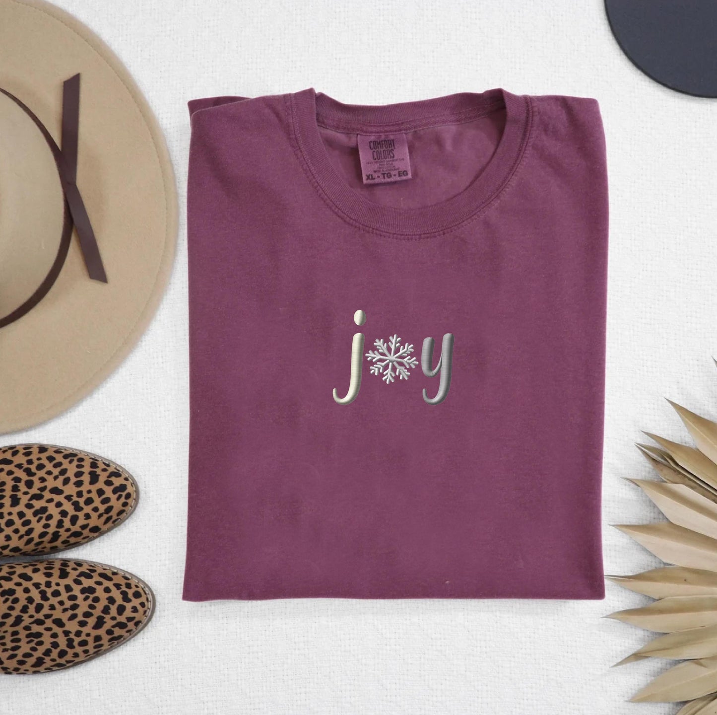 a t - shirt with the word joy printed on it
