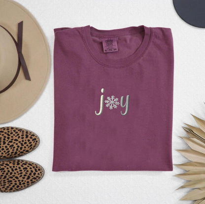 a t - shirt with the word joy printed on it